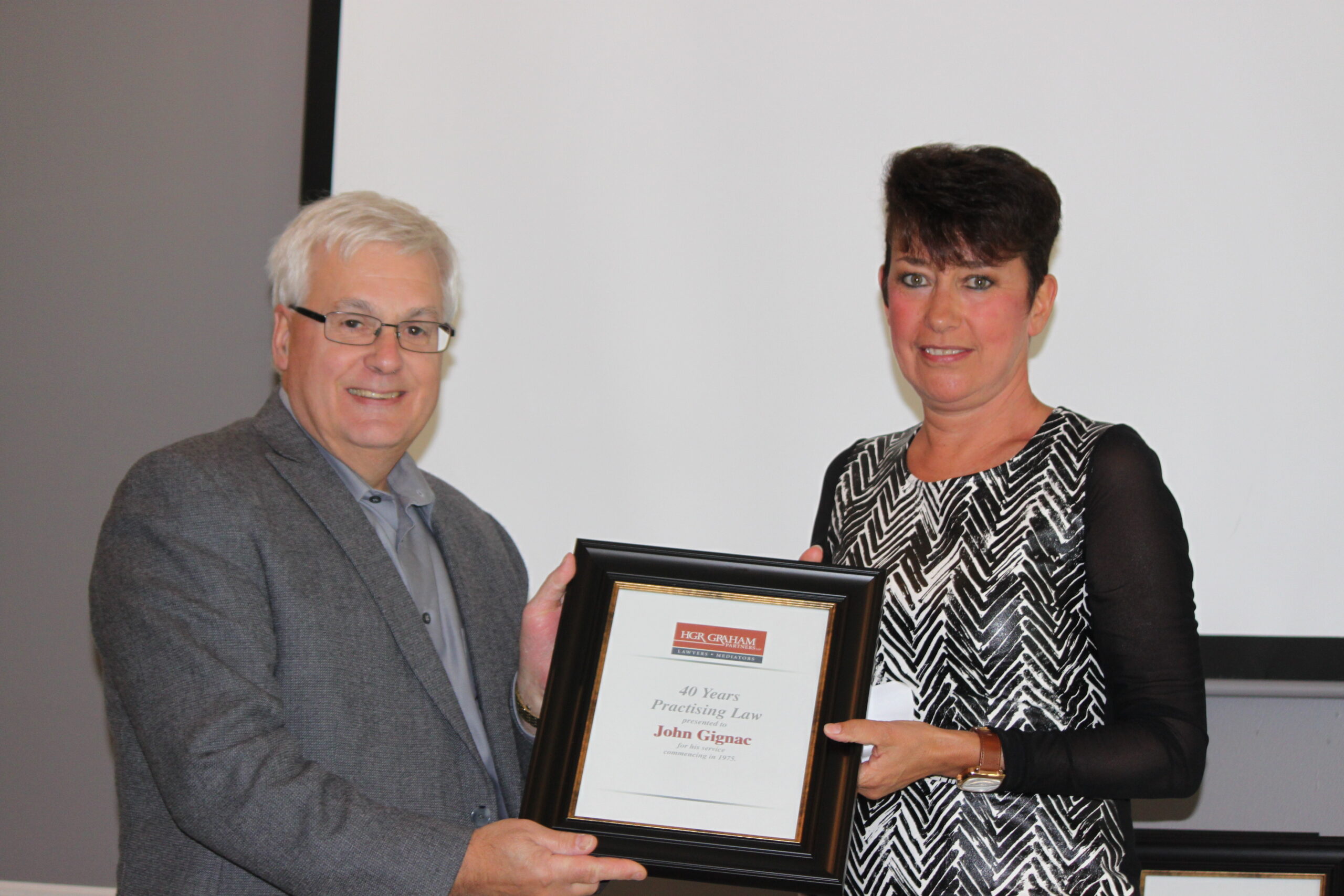 John Gignac accepting his award from Christine Manners